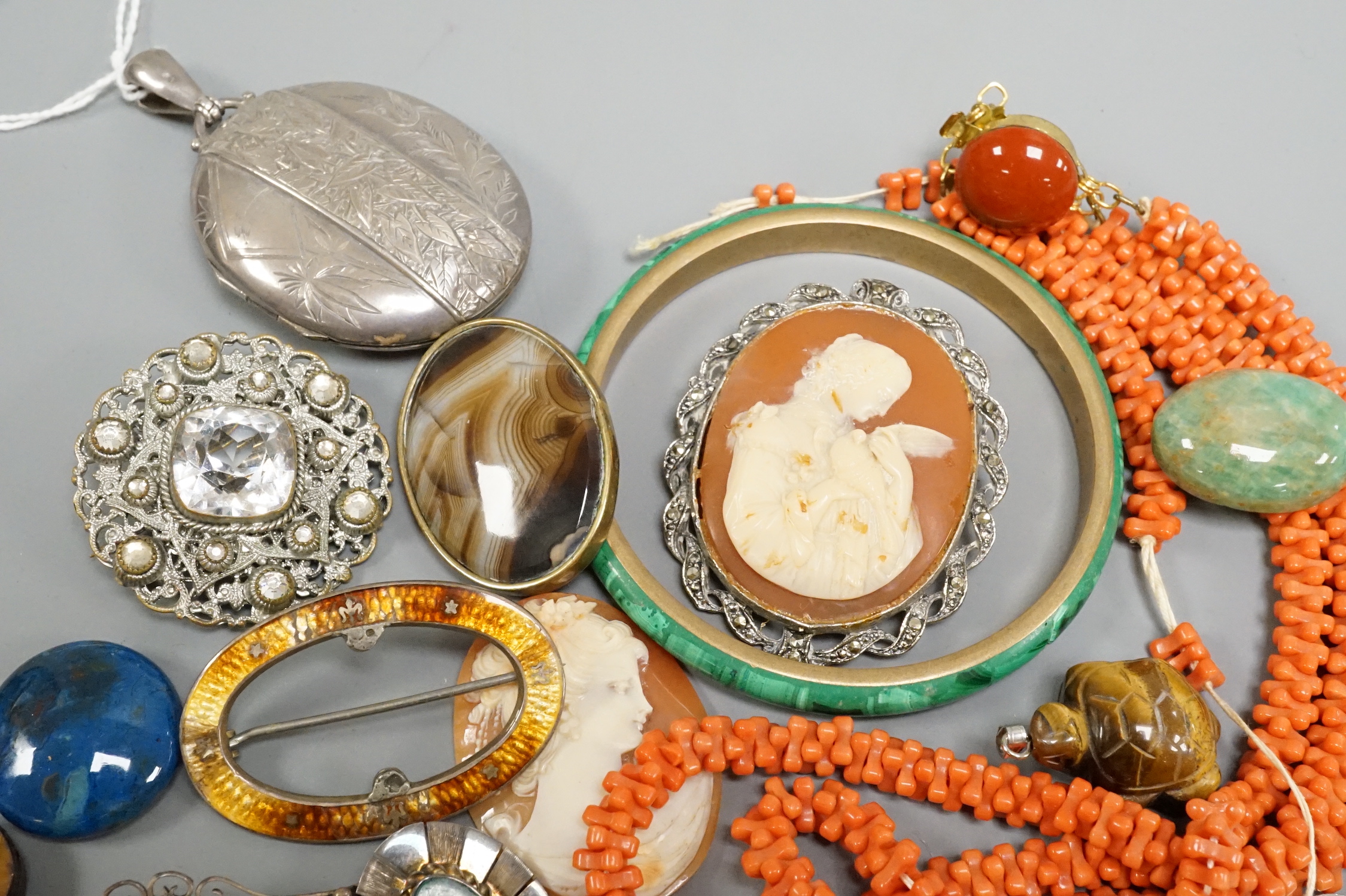 A Victorian silver oval locket and other jewellery including and coral necklace and white metal charm bracelet stamped 'silver, etc.